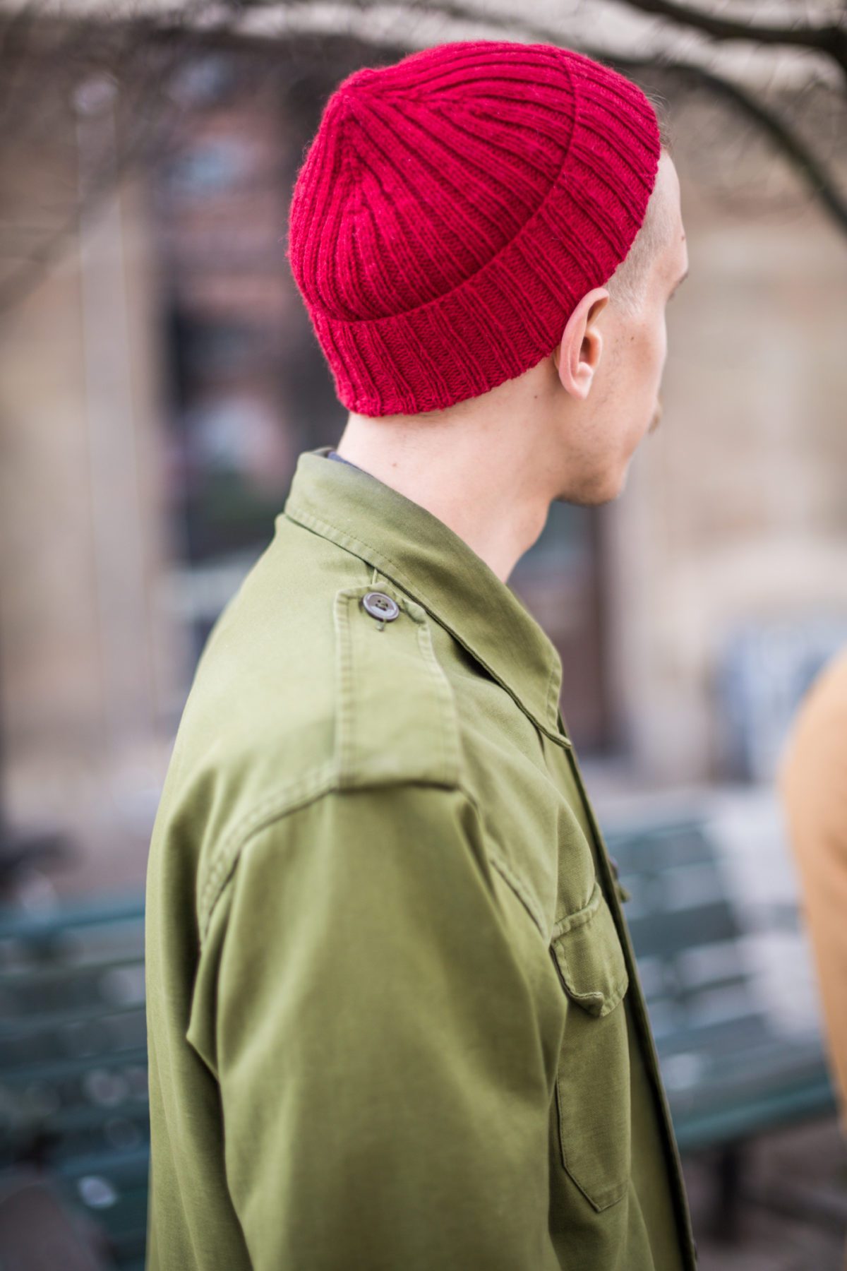 Red fisherman beanie with an army green jacket