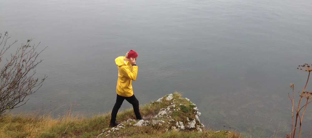 A red beanie with a yellow rain jacket.