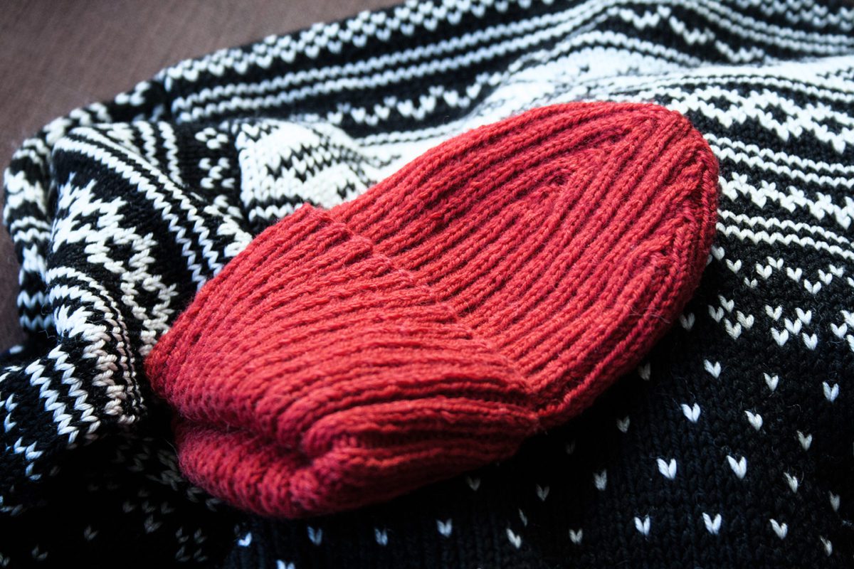 Red beanie on Norwegian traditional wool sweater.