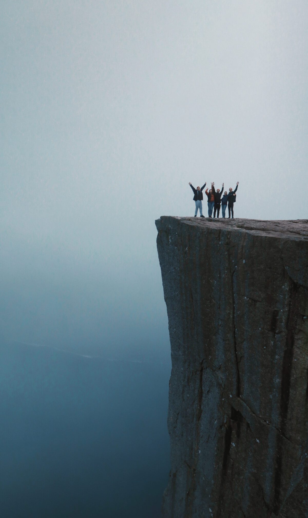Group of people standing on the Pulpit Rock / Preikestolen